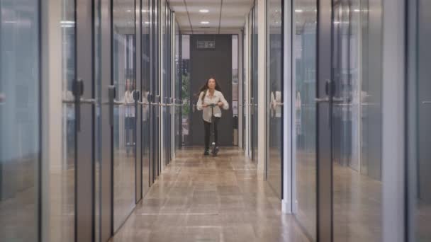 Businesswoman Riding Corridor Modern Office Scooter Shot Slow Motion — 图库视频影像