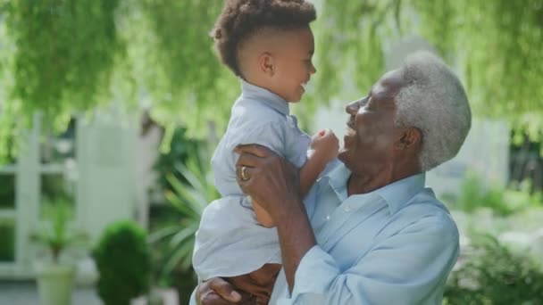 Loving Grandfather Holding Grandson Arms Hugging Talking Garden Together Shot — Wideo stockowe