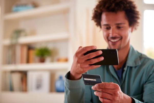 Man Credit Card Home Using Mobile Phone Review Finances Starting — Stock Photo, Image