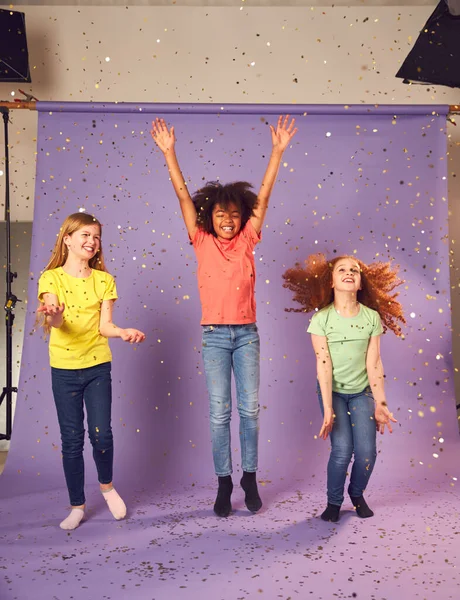 Studio Shot Children Glitter Jumping Air Outstretched Arms Purple Background — Stock fotografie