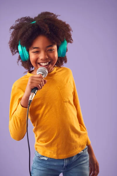 Studio Shot Boy Noszenie Słuchawki Śpiew Karaoke Mikrofonu Fioletowym Tle — Zdjęcie stockowe