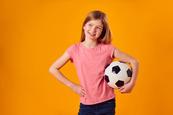 Studio Shot Young Girl Holding Soccer Ball Arm Yellow Background — Stock Photo, Image