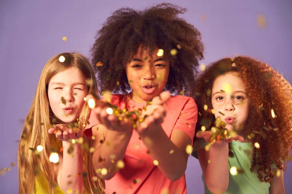 Studio Shot Children Blowing Glitter Hands Purple Background — Stock fotografie