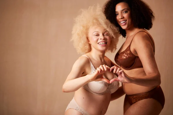 Shot Two Female Friends Underwear Making Heart Shape Hands Promoting — Stock Photo, Image