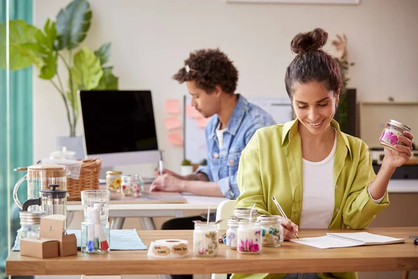 Couple Running Online Business Making Boutique Candles At Home Together