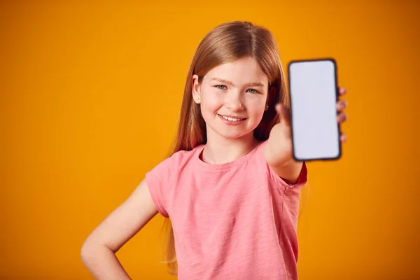 Studio Portrait Girl Showing Mobile Phone Social Media Screen Yellow — Stock Photo, Image