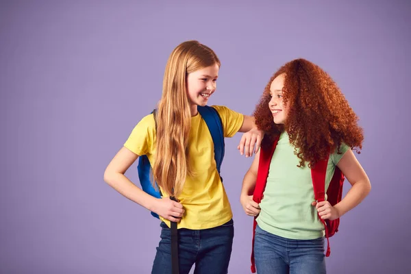 Studio Shot Two Girls Backpacks Going School Purple Background — Stock fotografie