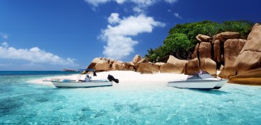 speed boat on the beach of Coco Island, Seychelles clipart