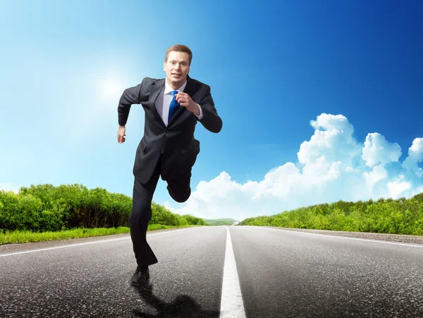 Business man run on the road Royalty Free Stock Photos