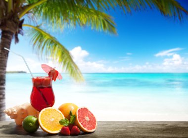 strawberry cocktail and tropical fruit on the beach clipart
