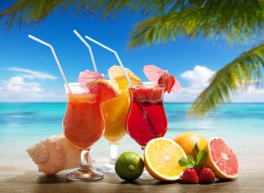Cocktaisl and tropical fruit on the beach clipart