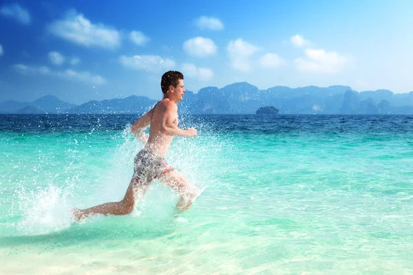 Running man in water of tropical sea — Stock Photo, Image