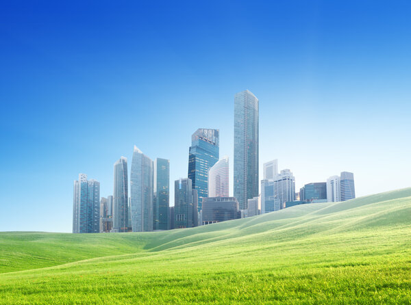 spring field and modern city