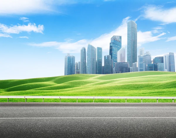 Asphalt road and modern city — Stock Photo, Image