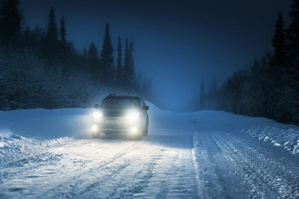 Car lights in winter Russian forest — Stock Photo, Image