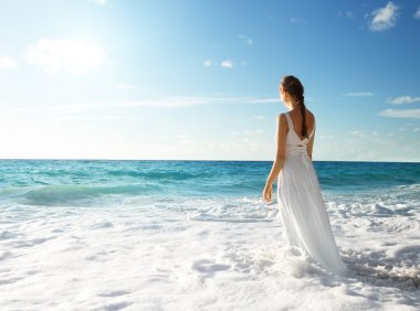 young woman standing in sea waves  clipart