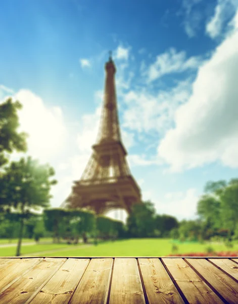 Eiffel tower in Paris and wooden surface — Stock Photo, Image