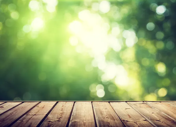 Wooden surface and sunny forest — Stock Photo, Image