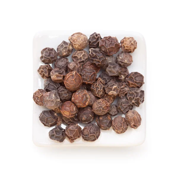 Black pepper (Piper nigrum) in a white bowl on white background. — Stock Photo, Image