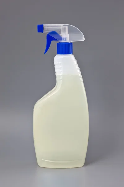 Transparent detergent plastic spray bottle isolated on gray — Stock Photo, Image