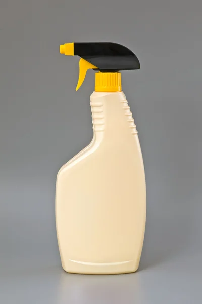 Beige detergent plastic spray bottle Isolated on gray — Stock Photo, Image