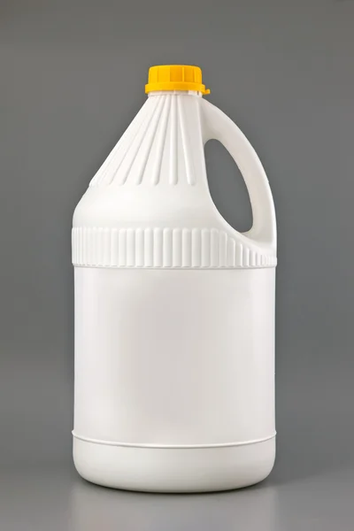White detergent plastic bottle isolated on gray — Stock Photo, Image