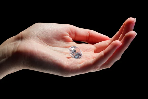 Kvinnlig hand innehav diamond — Stockfoto