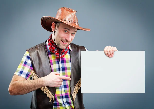 Cheerful cowboy holding a banner — Stock Photo, Image