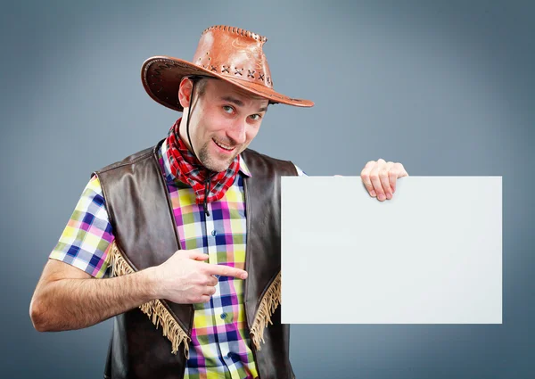 Vaquero alegre sosteniendo una pancarta — Foto de Stock