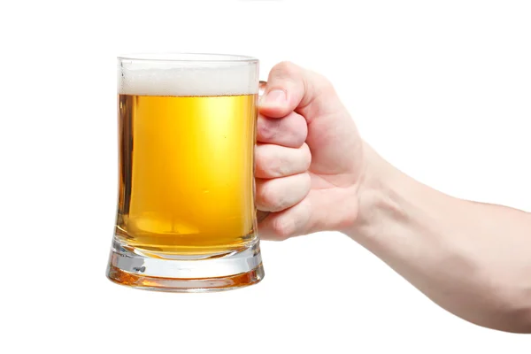 Closeup of a male hand holding up a glass of beer over a white b — Stock Photo, Image