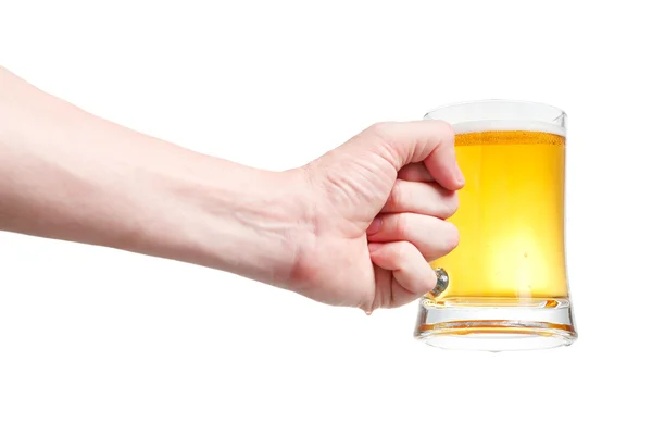 Closeup of a male hand holding up a glass of beer over a white b — Stock Photo, Image