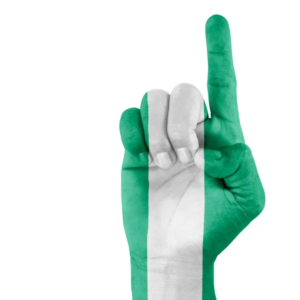 Bandera de Nigeria en apuntar hacia arriba mano — Foto de Stock