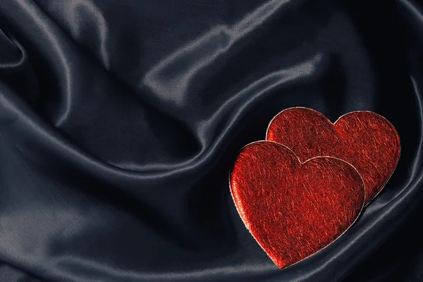 Two hearts on black silk — Stock Photo, Image