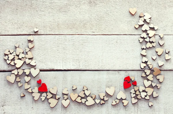 Valentines Day Background Many Small Wooden Hearts White Wooden Table — Stockfoto