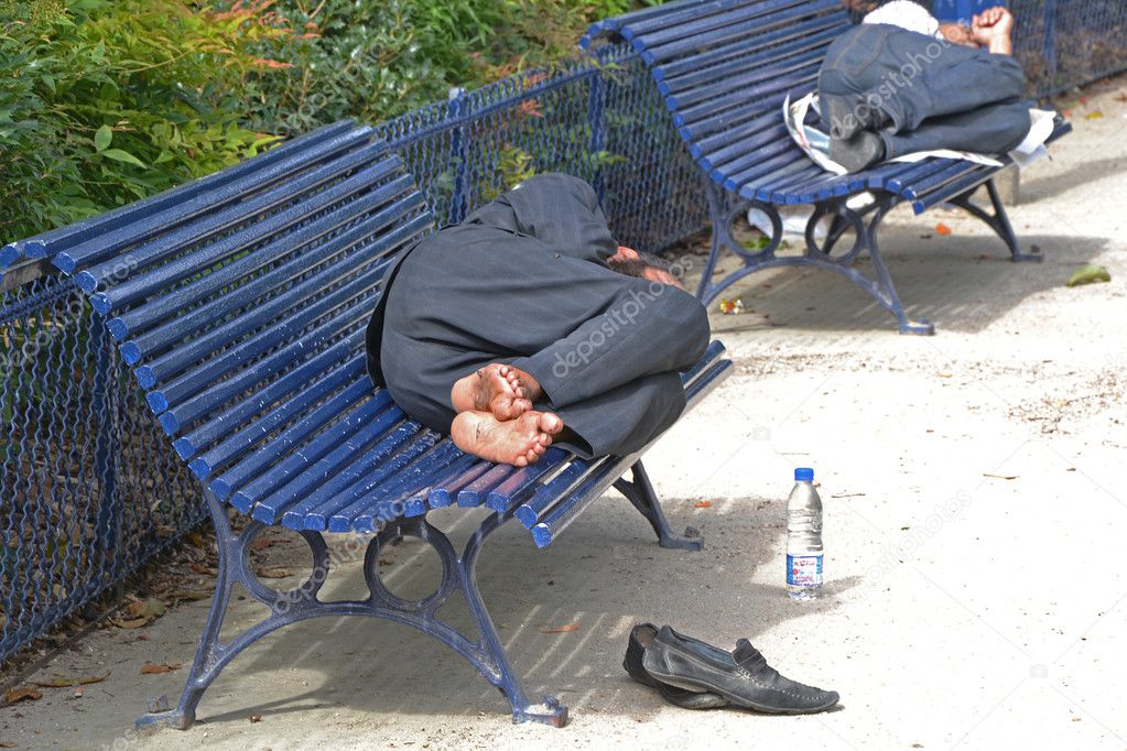 Homeless sleeping on benches