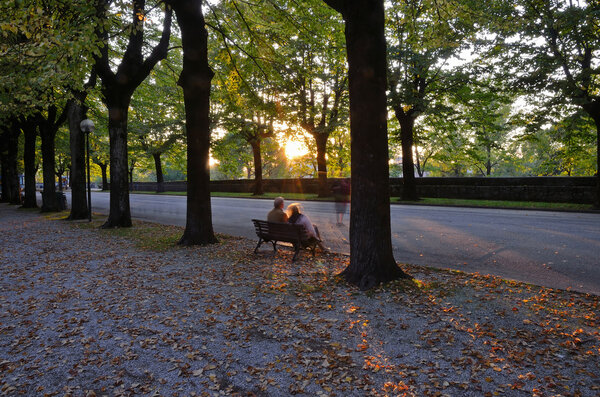 Couple on bench at sunset