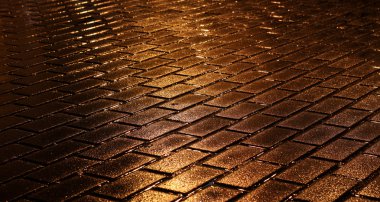 shining golden lights on wet pavement clipart