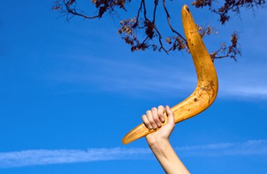 Boomerang in front of a blue sky clipart