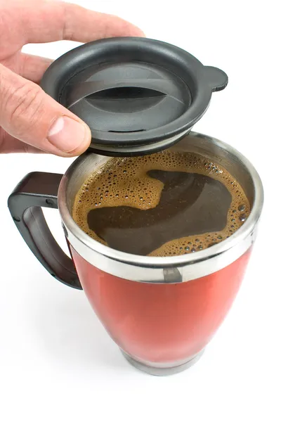 Red thermos with coffee drink and lid in hand — Stock Photo, Image