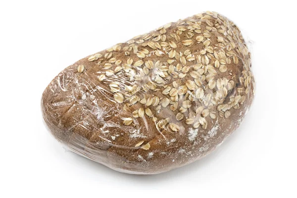 Baked bread with seeds wrapped in cellophane — Stock Photo, Image