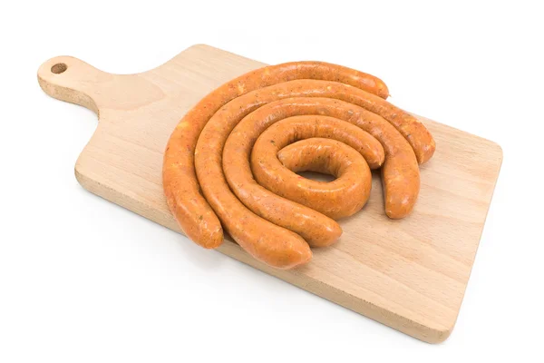 Raw sausages on wooden board — Stock Photo, Image