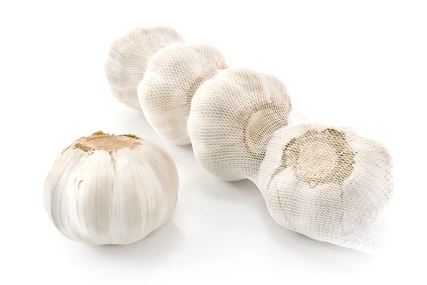 Garlic bulbs in net — Stock Photo, Image