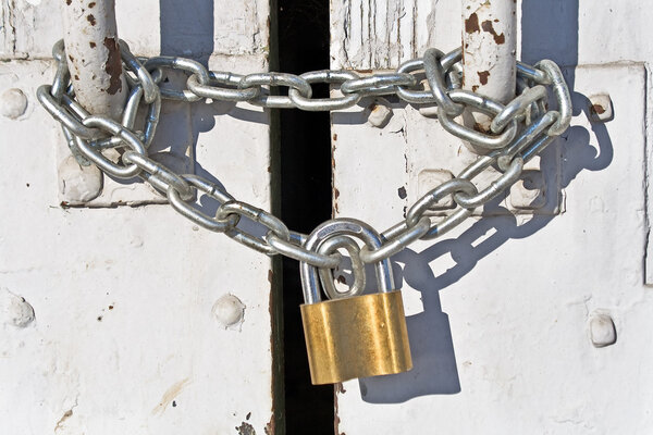 Padlock with chain on old door