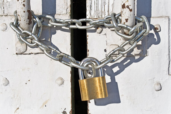 Padlock with chain on old door Stock Image