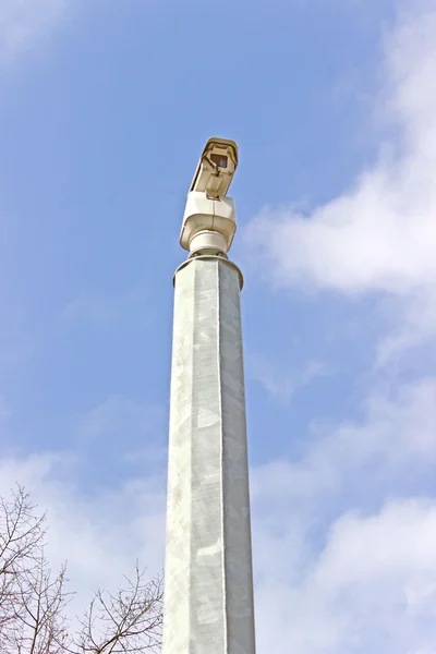 Security camera against blue sky — Stock Photo, Image