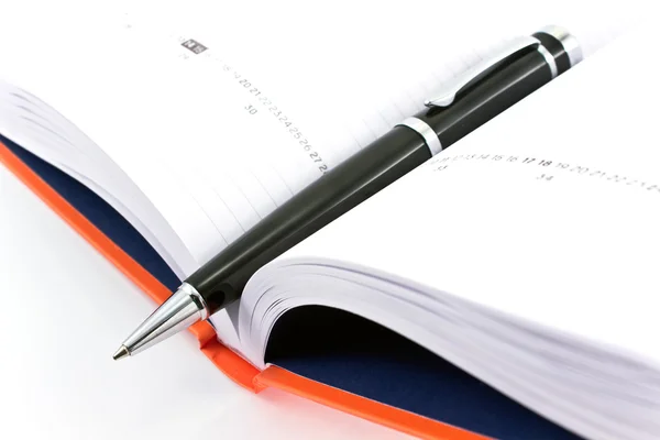 Pen on open notebook — Stock Photo, Image