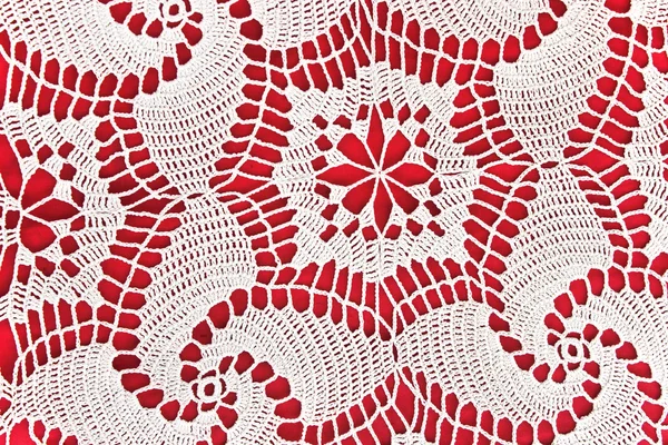 Handmade white lace on red s background — Stock Photo, Image