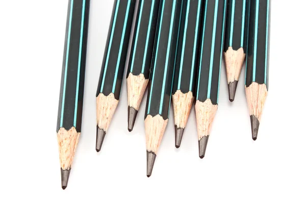 Černé dřevěné tužky na bílém pozadí — Stock fotografie