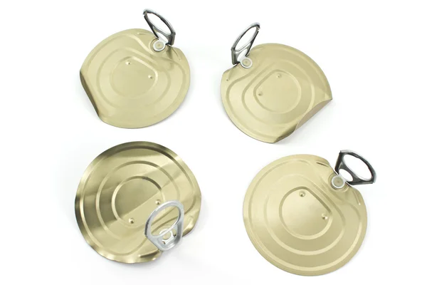 Four tin can lids with opener isolated on white — Stock Photo, Image