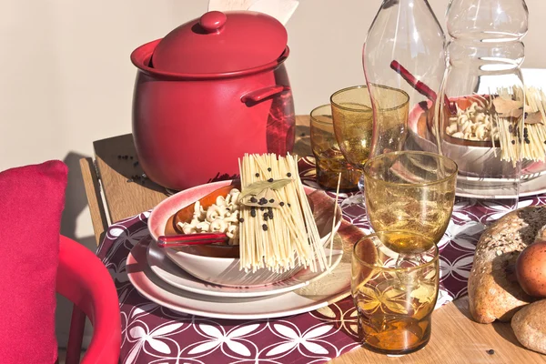 Накрытие стола сухими спагетти на тарелки — стоковое фото